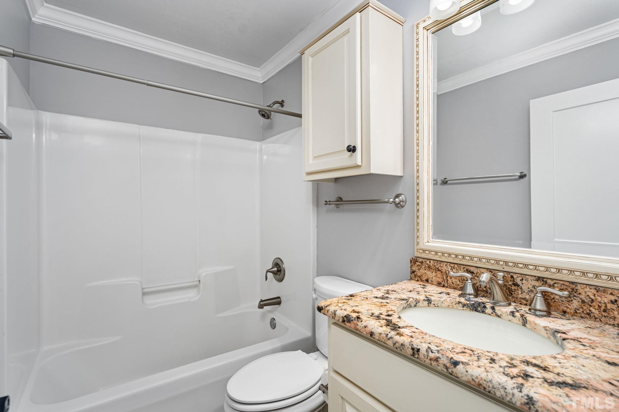 5219 Cardinal Grove Boulevard Raleigh, NC 27616 - Photo 23 of 43 a bathroom with a sink toilet vanity and shower