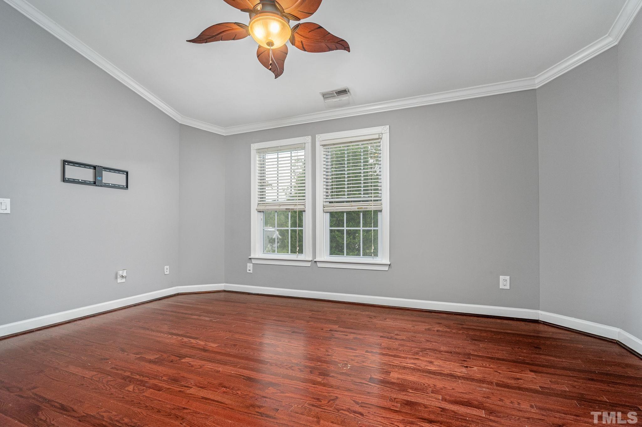 5219 Cardinal Grove Boulevard Raleigh, NC 27616 - Photo 26 of 43 a view of an empty room with wooden floor and a window