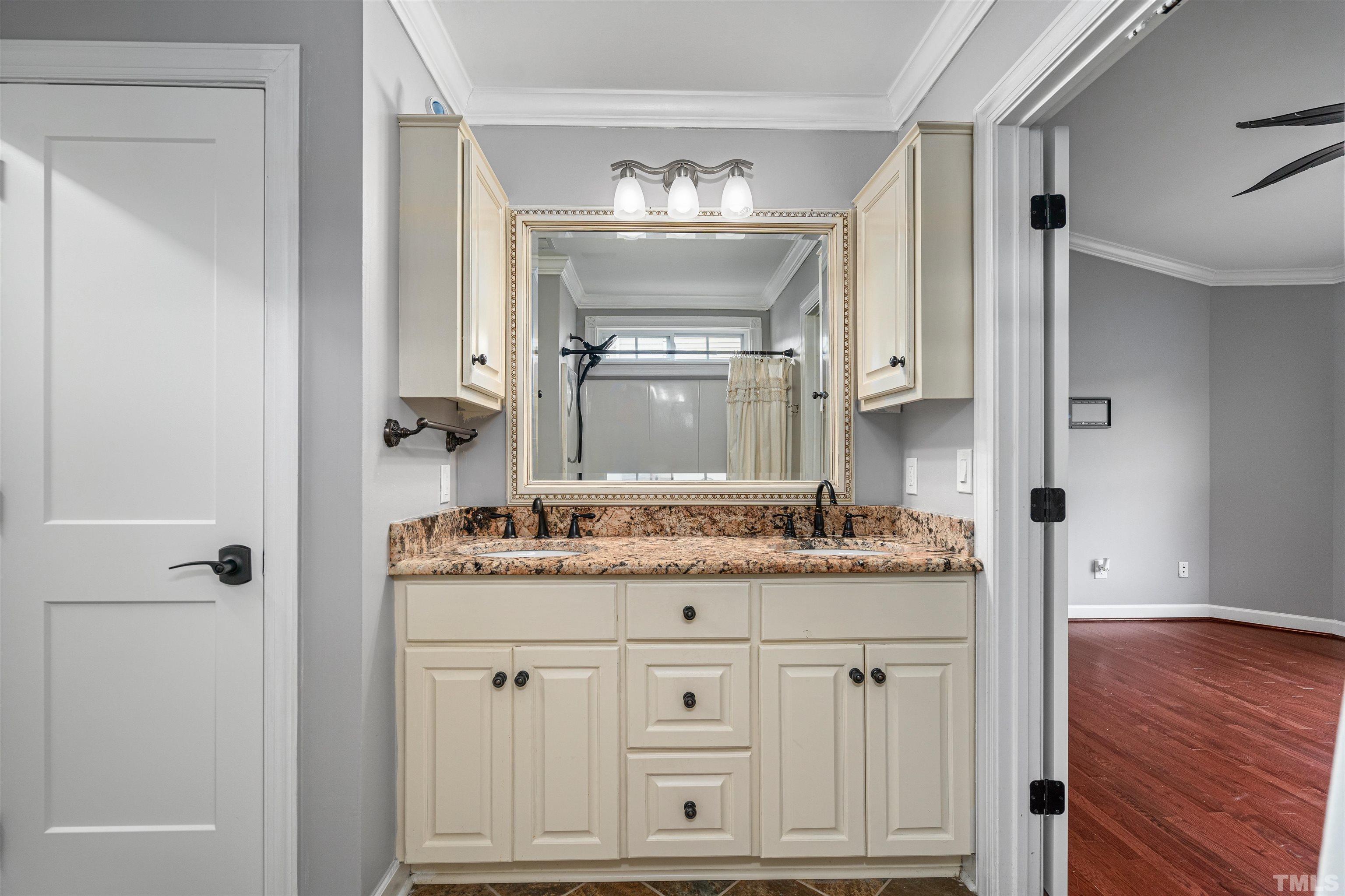 5219 Cardinal Grove Boulevard Raleigh, NC 27616 - Photo 28 of 43 a bathroom with a granite countertop double vanity sink and mirror