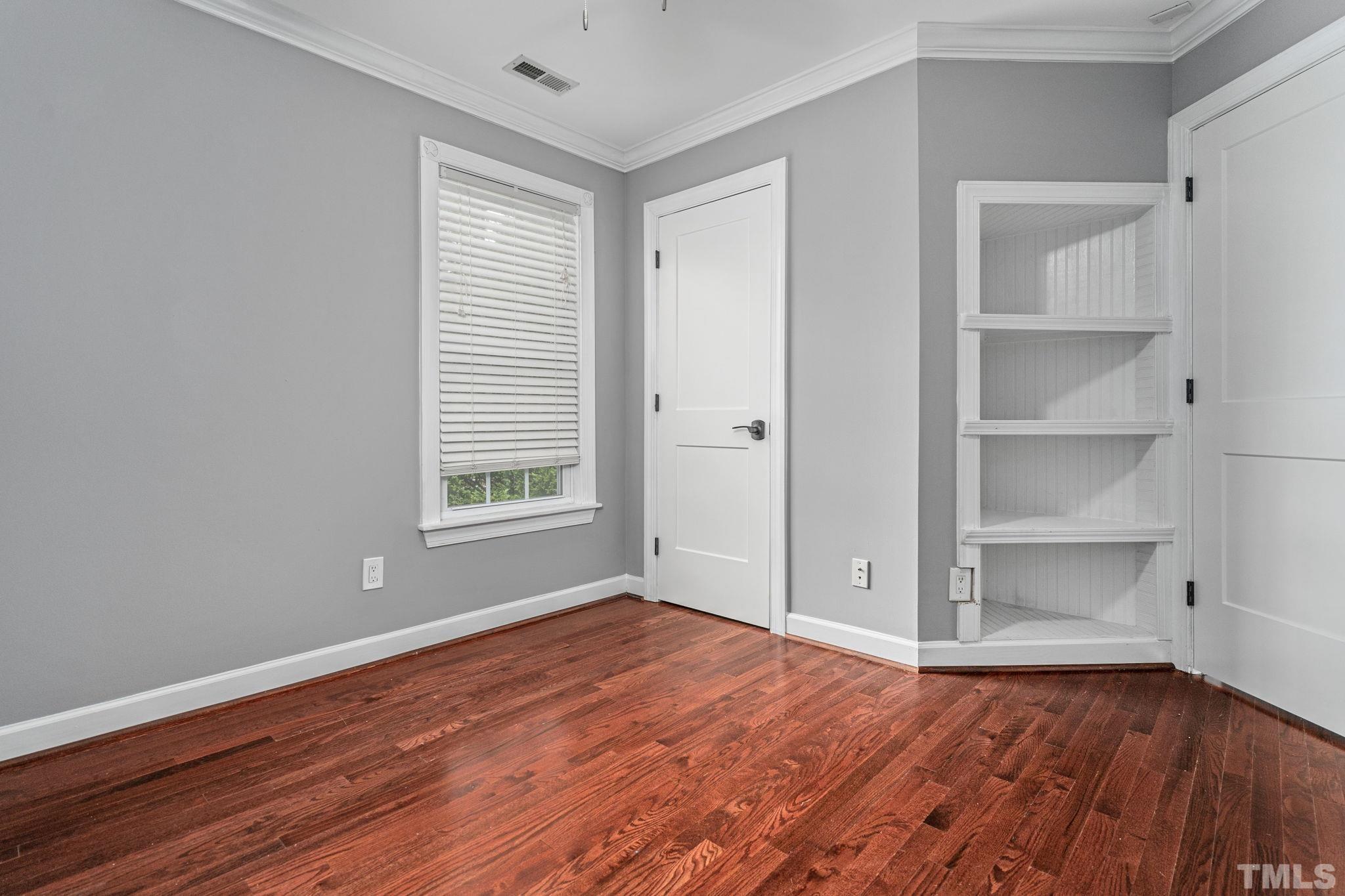 5219 Cardinal Grove Boulevard Raleigh, NC 27616 - Photo 32 of 43 a view of an empty room with wooden floor and a window