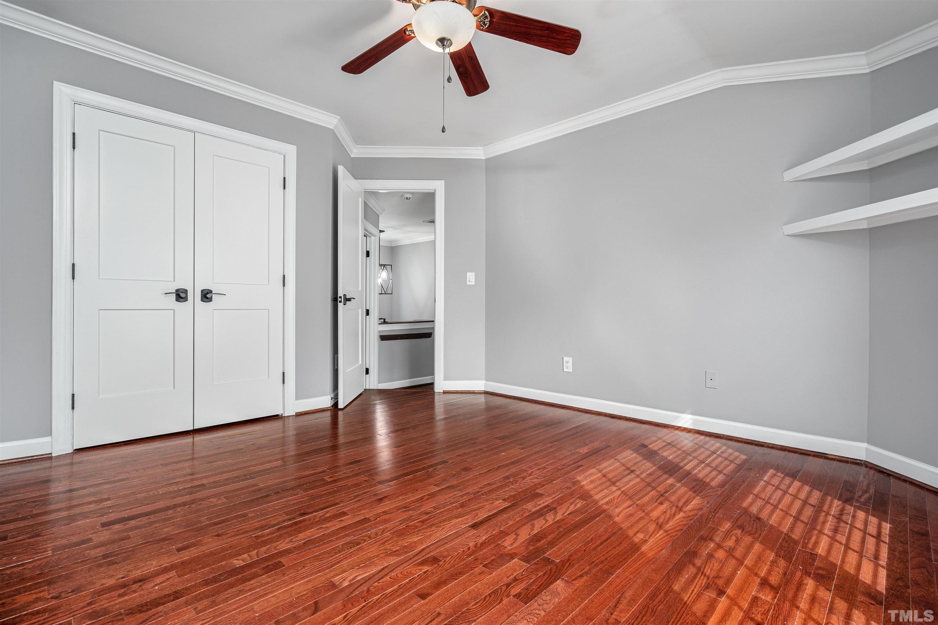 5219 Cardinal Grove Boulevard Raleigh, NC 27616 - Photo 36 of 43 a view of an empty room with wooden floor and a window