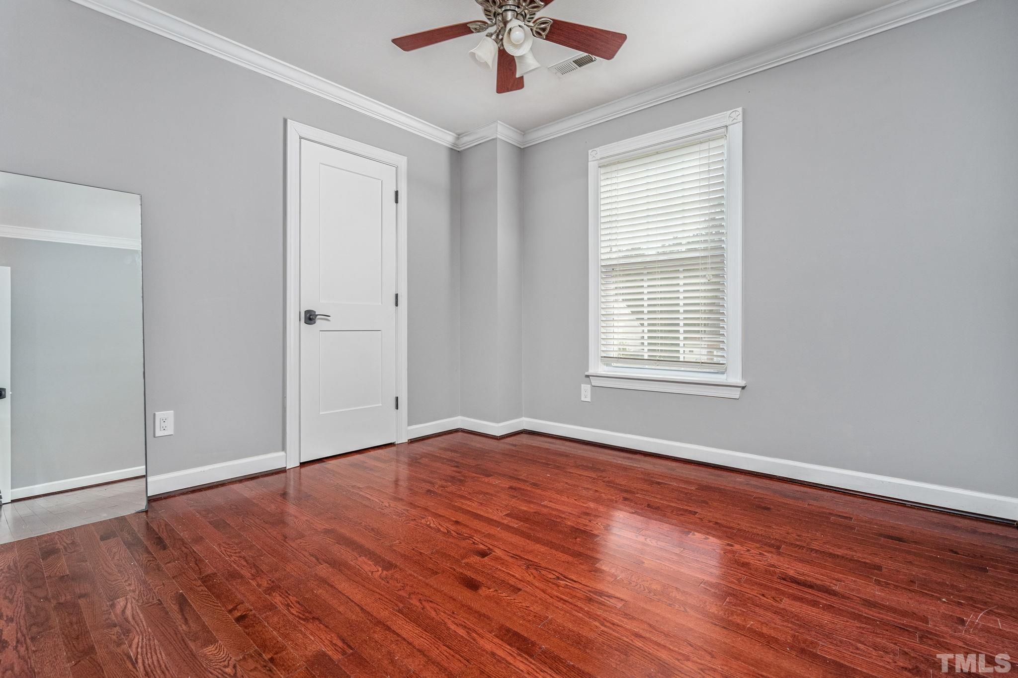 5219 Cardinal Grove Boulevard Raleigh, NC 27616 - Photo 37 of 43 a view of an empty room with window and wooden floor