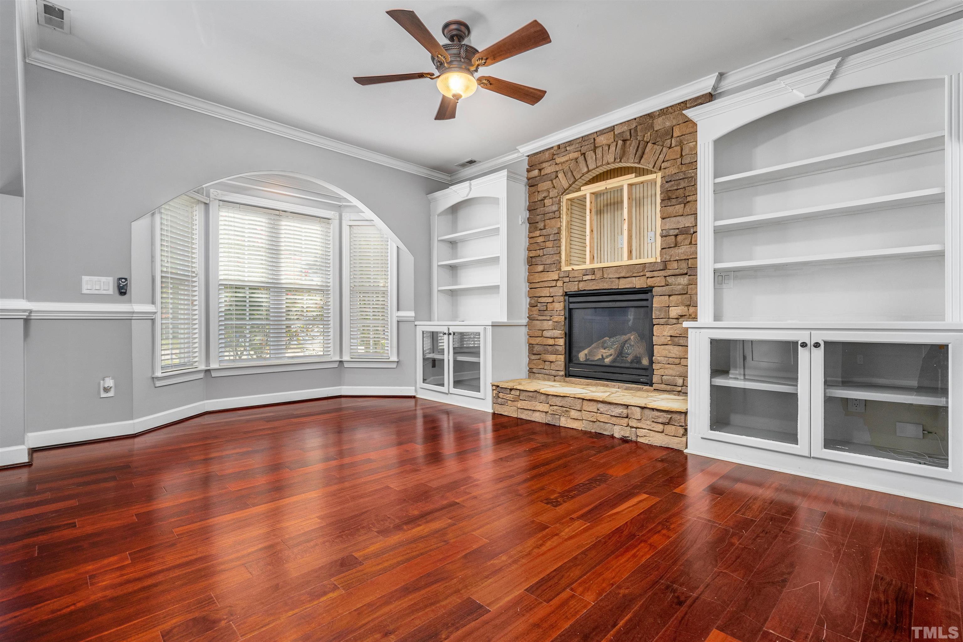 5219 Cardinal Grove Boulevard Raleigh, NC 27616 - Photo 6 of 43 a view of an empty room with wooden floor and a window