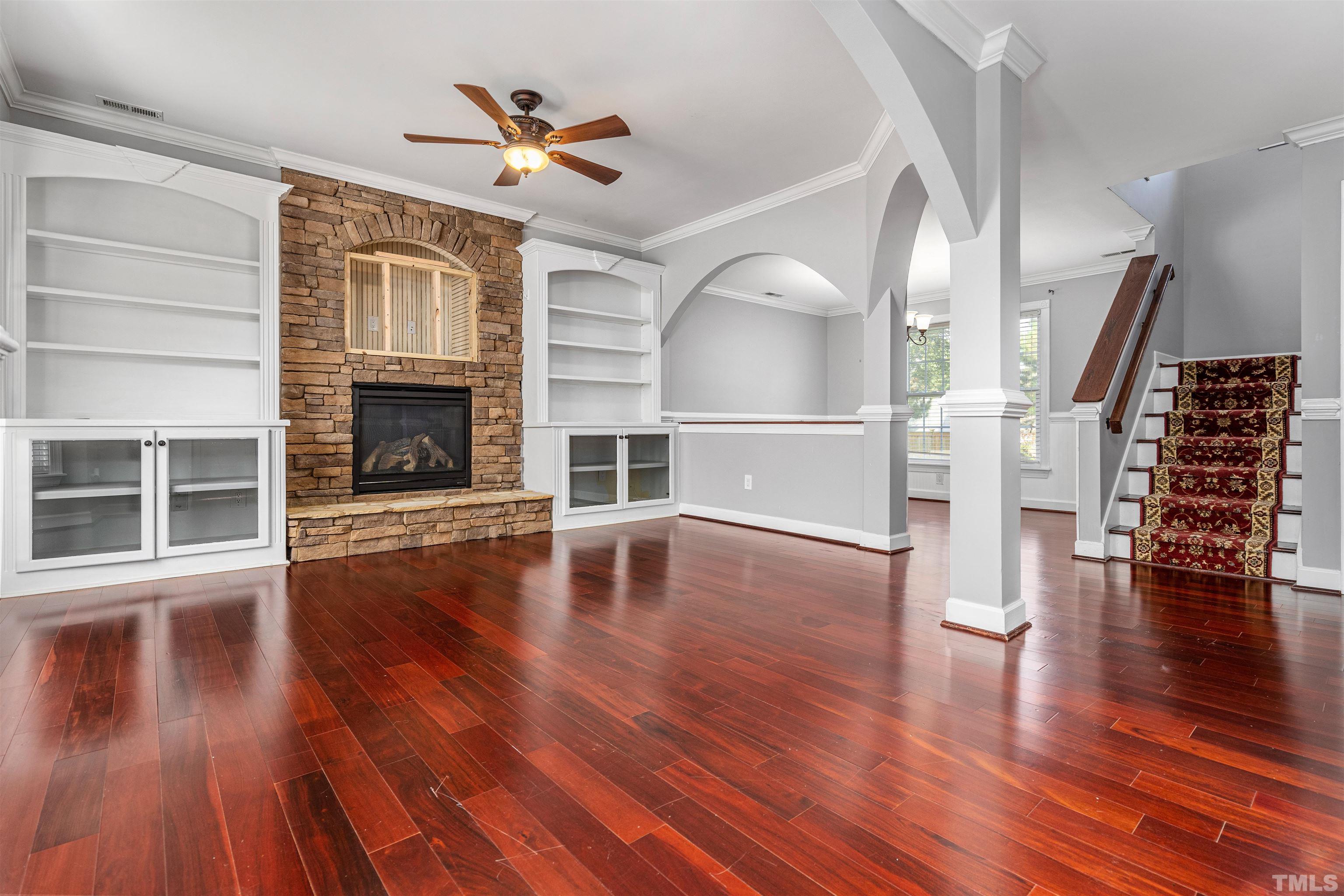 5219 Cardinal Grove Boulevard Raleigh, NC 27616 - Photo 7 of 43 a view of empty room with wooden floor and fireplace