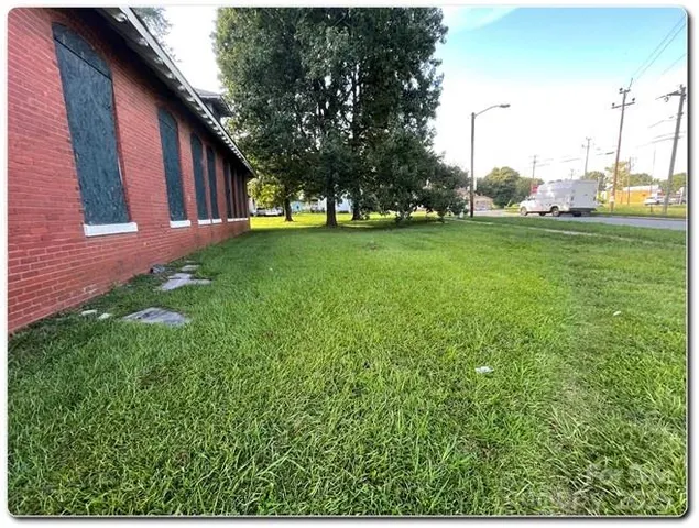 a front view of house with a garden