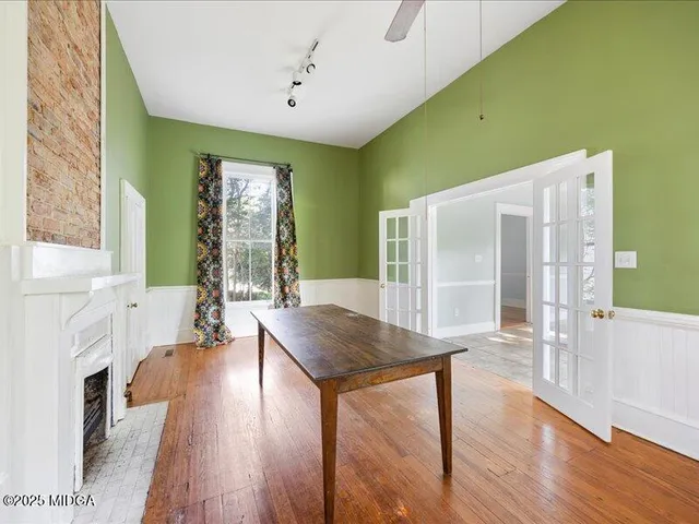 a living room with stainless steel appliances granite countertop furniture and a fireplace