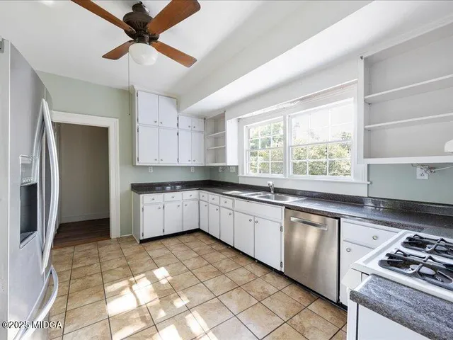 a kitchen with a stove a sink and a refrigerator