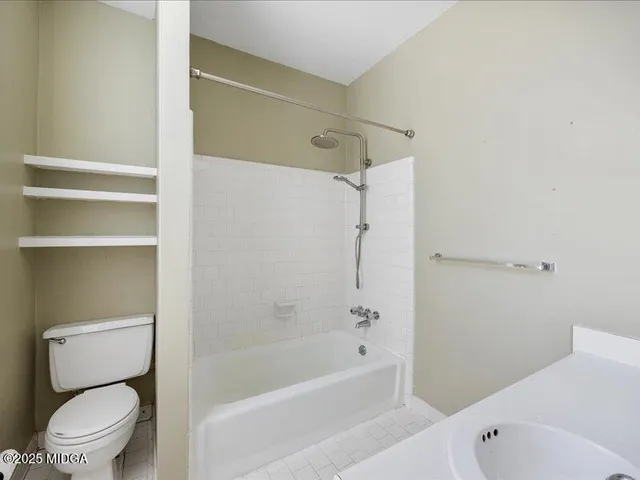 a bathroom with a toilet and a bathtub