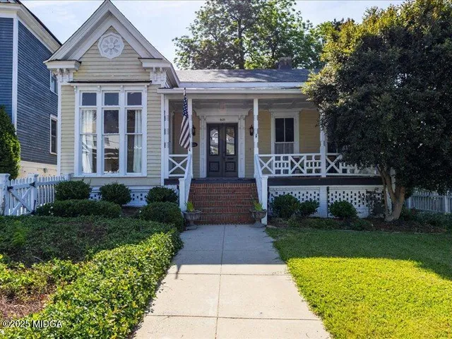 a front view of a house with garden