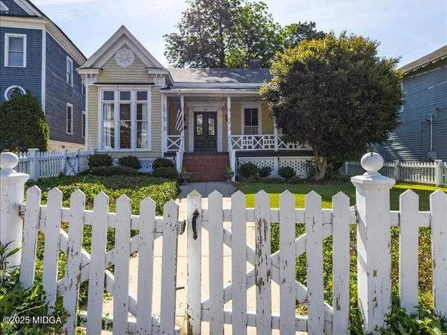 a front view of house and yard with green space