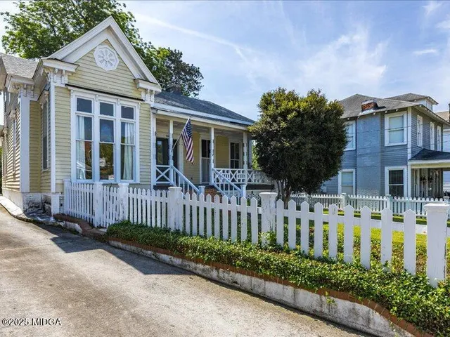 a front view of a house with a garden