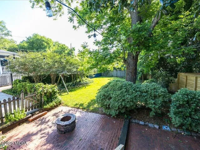 a view of a backyard with sitting area