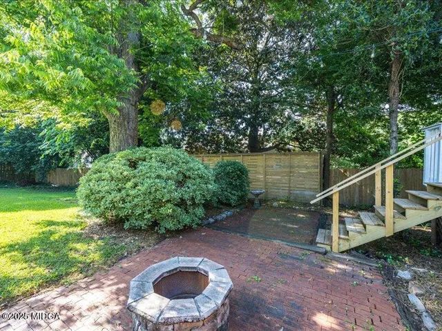 a backyard of a house with outdoor seating and lake