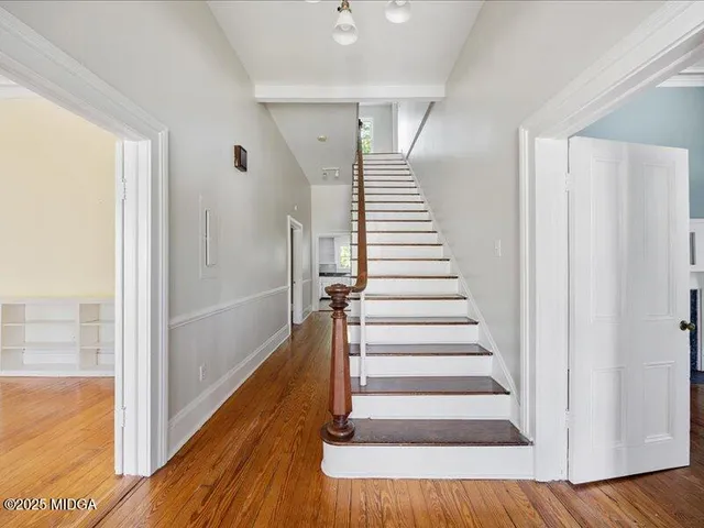 a view of entryway and hall with wooden floor