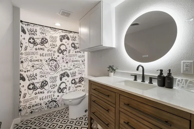 a walk in closet with wooden floor and mirror