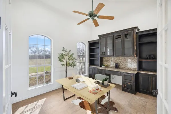 a living room with fireplace furniture and a large window
