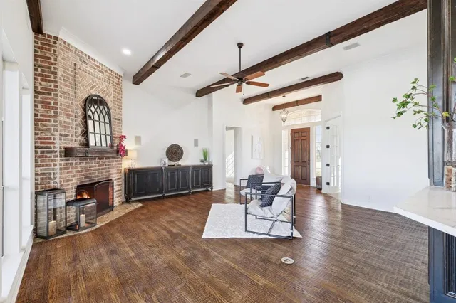 a living room with wooden floors and a fireplace