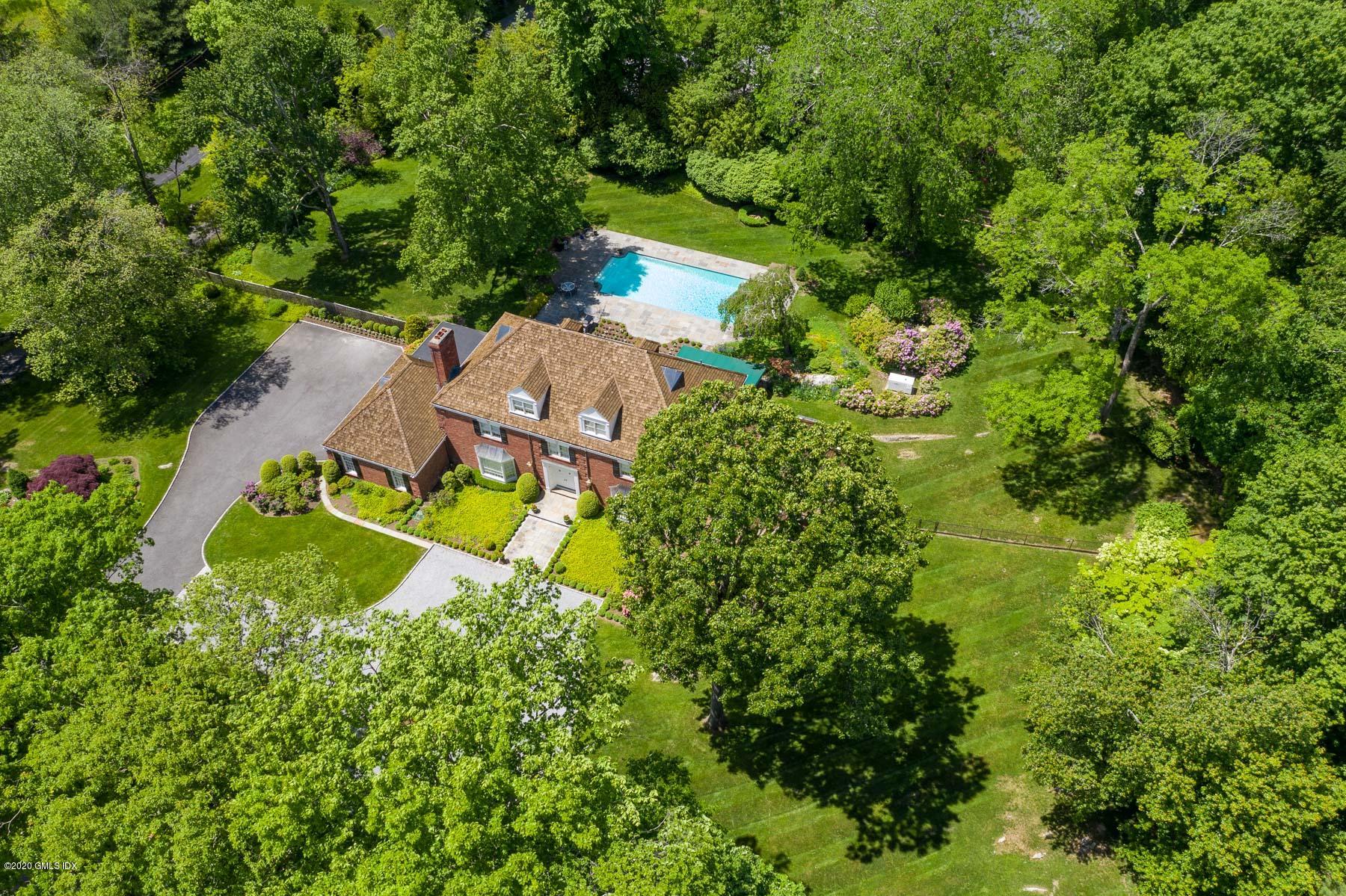 an aerial view of a house with yard swimming pool and outdoor seating