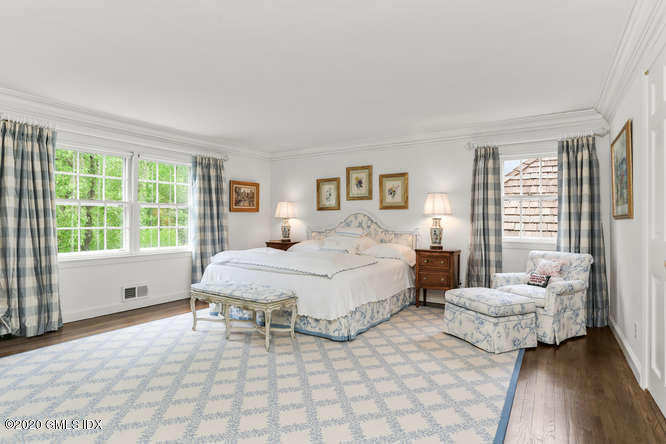 191 Clapboard Ridge Road Greenwich, CT 06831 - Photo 15 of 23 a spacious bedroom with a bed and a large window