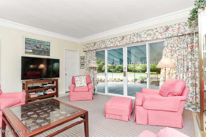 191 Clapboard Ridge Road Greenwich, CT 06831 - Photo 10 of 23 a living room with furniture a flat screen tv and a floor to ceiling window