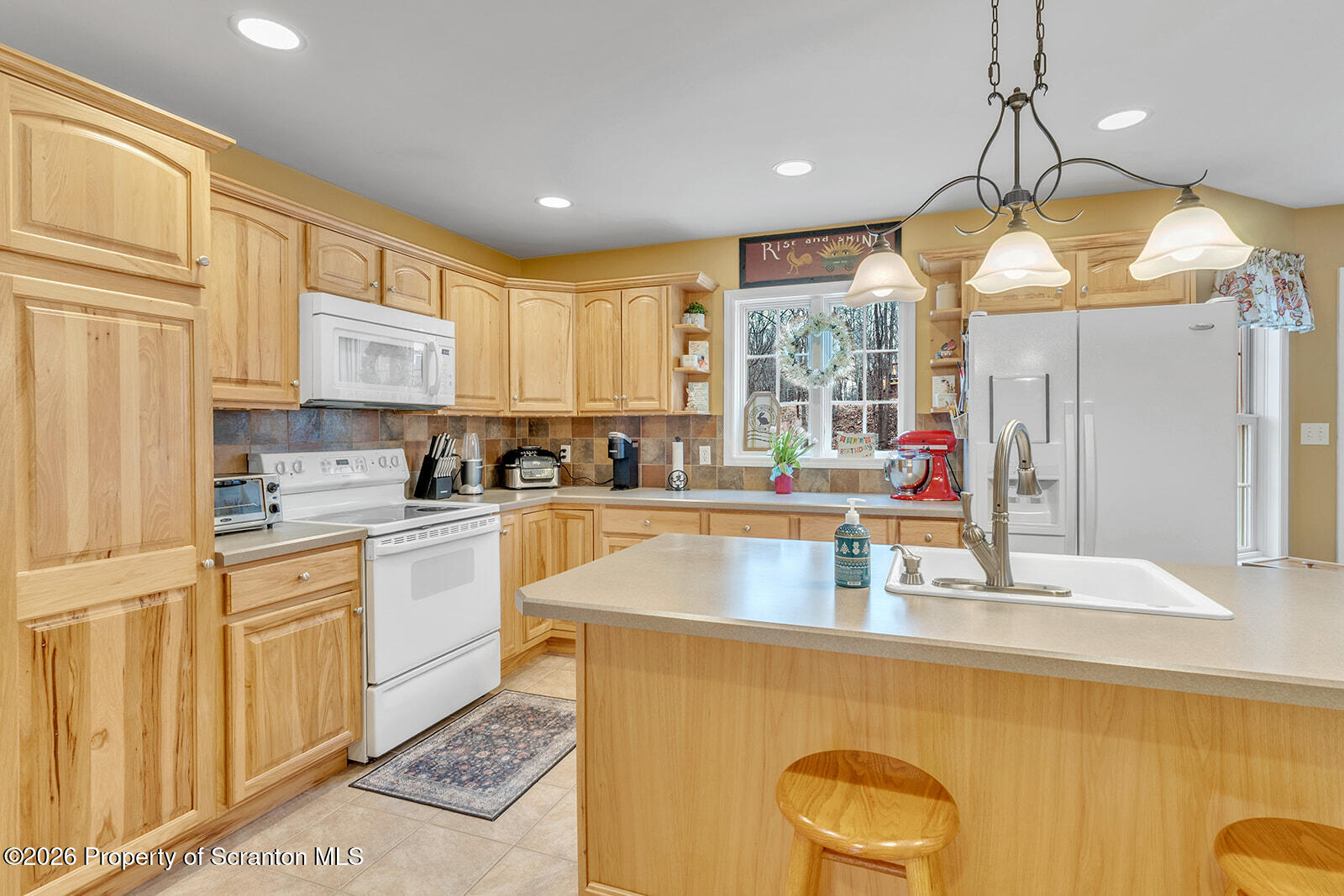1611 Cherry Street Scranton, PA 18505 - Photo 31 of 86 a kitchen with stainless steel appliances granite countertop a sink a stove cabinets counter space and a window