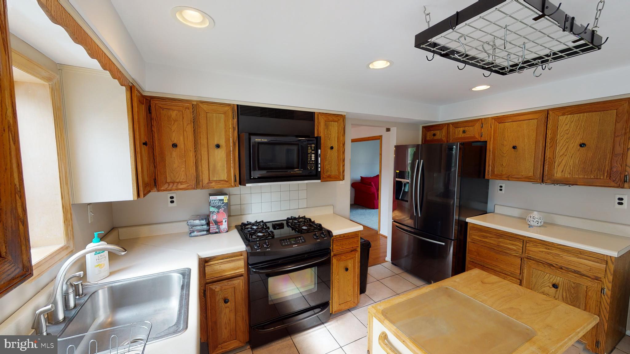 2 Candlestick Road Clementon, NJ 08021 - Photo 14 of 40 a kitchen with stainless steel appliances granite countertop a sink stove and refrigerator