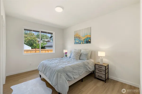 a bedroom with a bed and a painting on the wall
