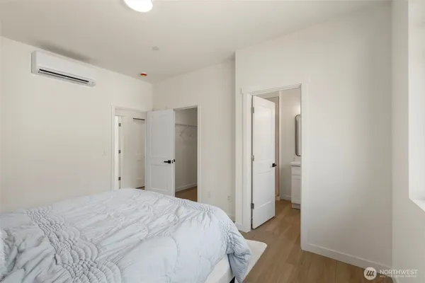 a bedroom with a bed and a mirror