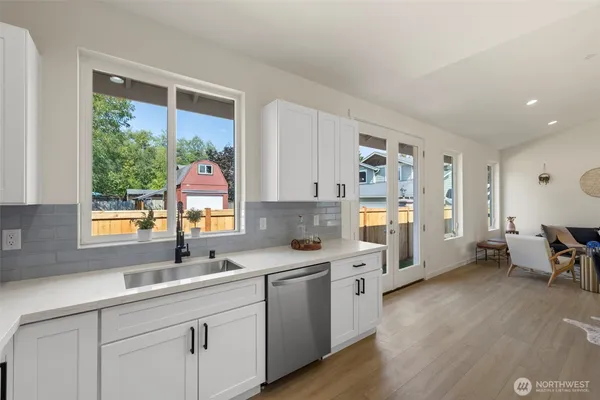 a kitchen with a sink cabinets and window