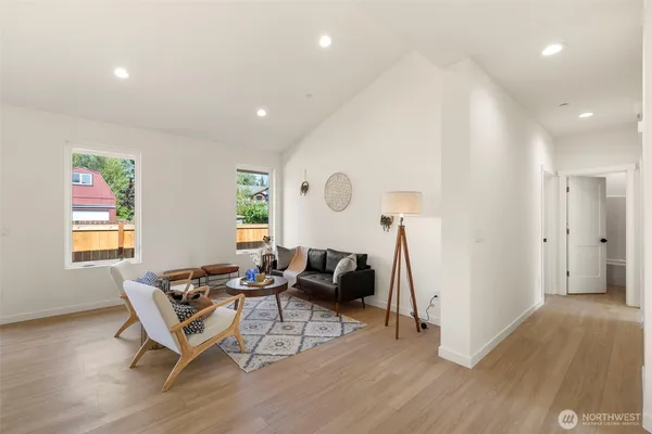 a living room with furniture and a wooden floor