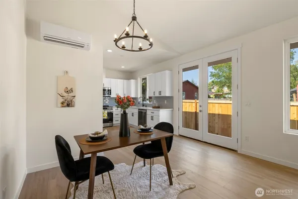 a view of a dining room with furniture a chandelier and wooden floor