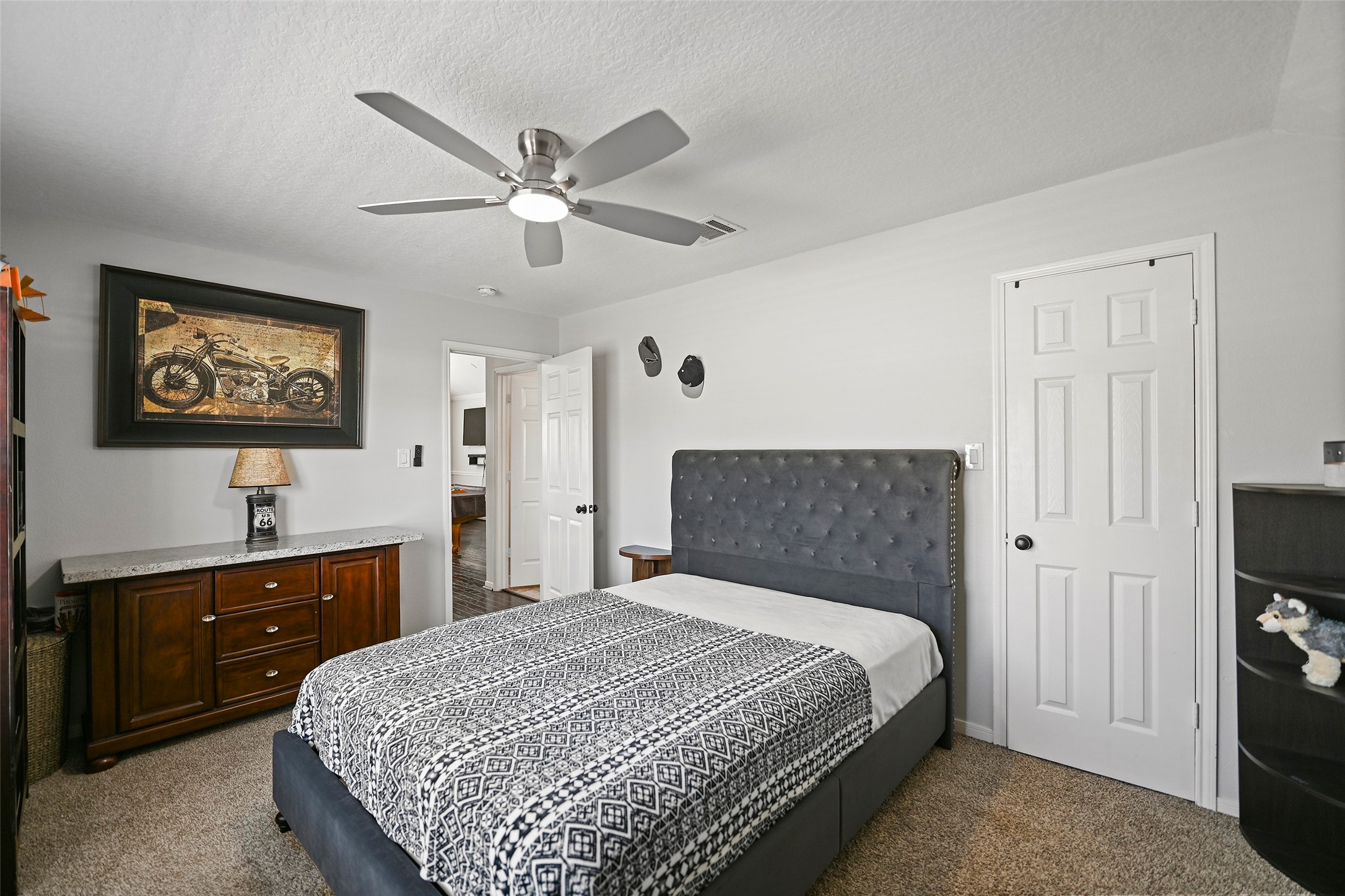 25119 Aughton Drive Spring, TX 77389 - Photo 29 of 41 a bedroom with a bed and a flat tv screen on dresser