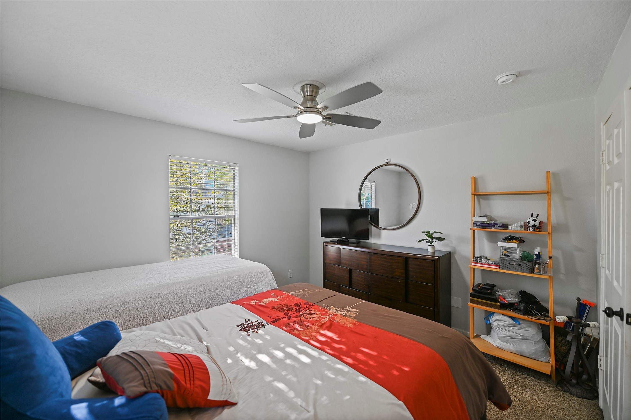 25119 Aughton Drive Spring, TX 77389 - Photo 38 of 41 a bedroom with bed and a chandelier