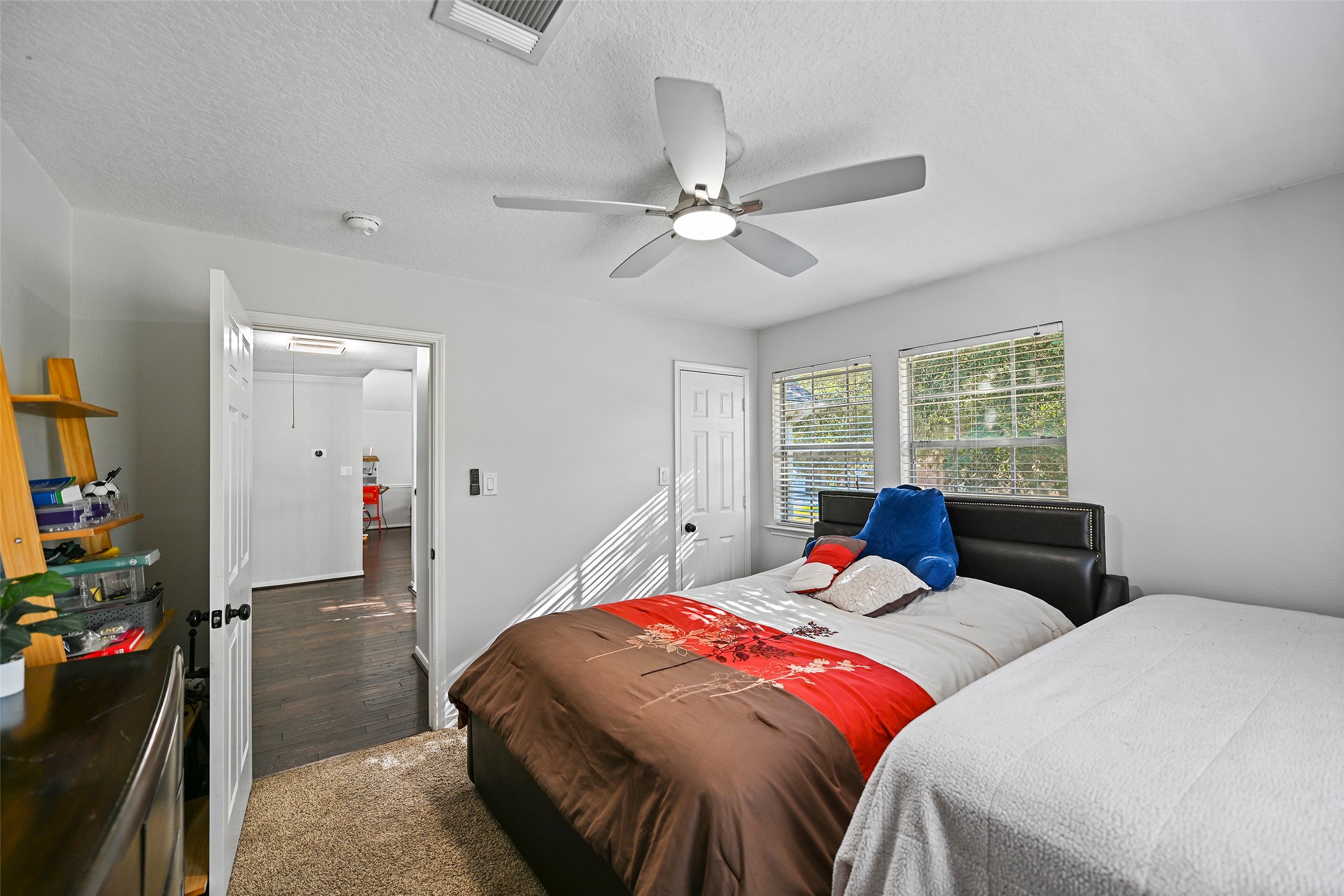 25119 Aughton Drive Spring, TX 77389 - Photo 39 of 41 a bedroom with a bed and a chandelier