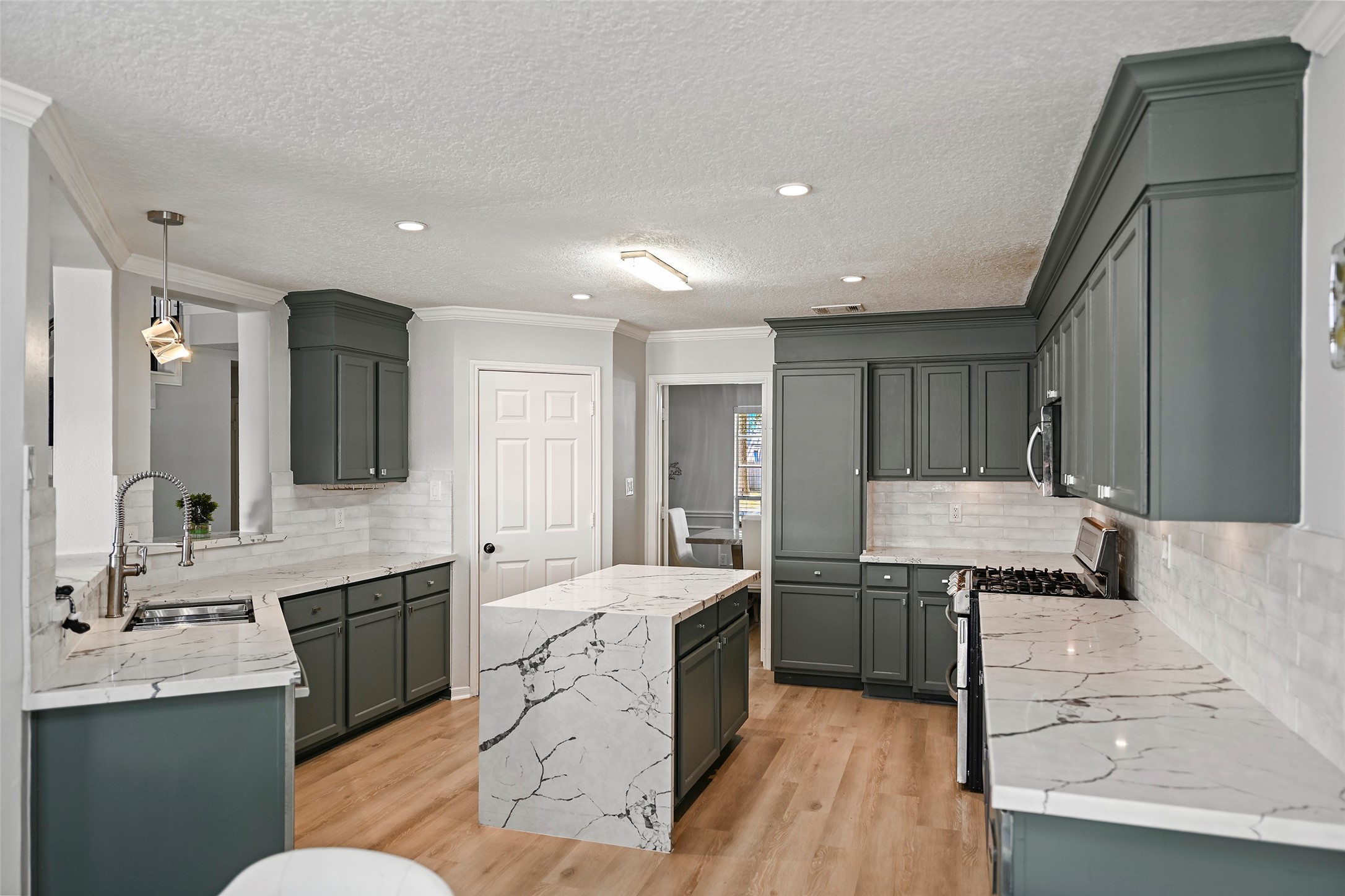 25119 Aughton Drive Spring, TX 77389 - Photo 10 of 41 a large kitchen with a sink stainless steel appliances and cabinets