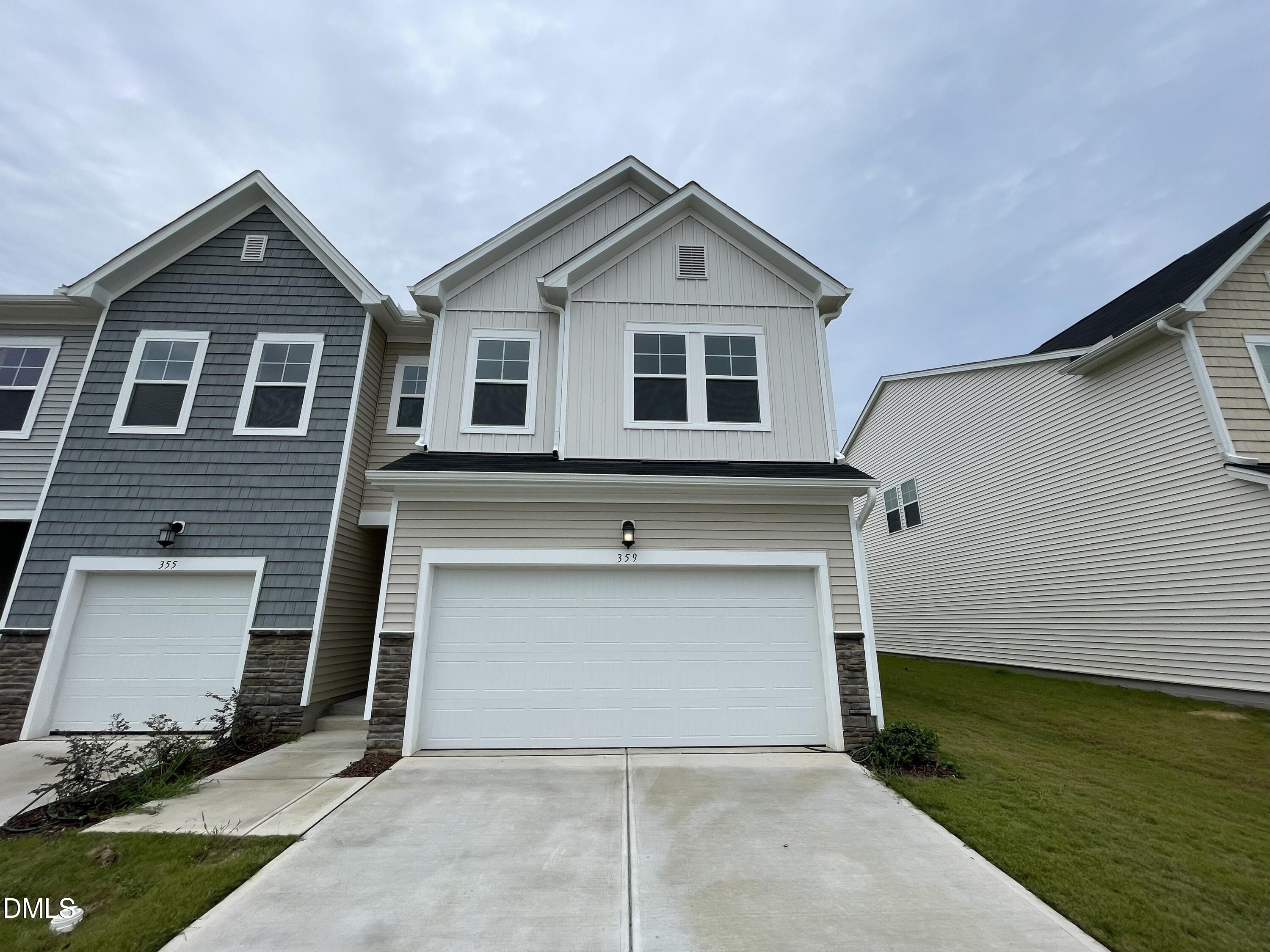 359 Thompson Overlook Way Smithfield, NC 27577 - Photo 1 of 42 a front view of a house with a yard and garage