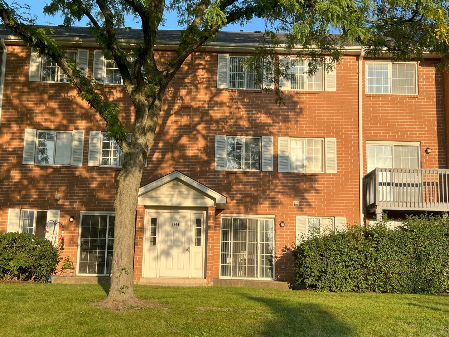 1344 South Lorraine Road, Unit F Wheaton, IL 60189 - Photo 24 of 27 front view of a house with a yard