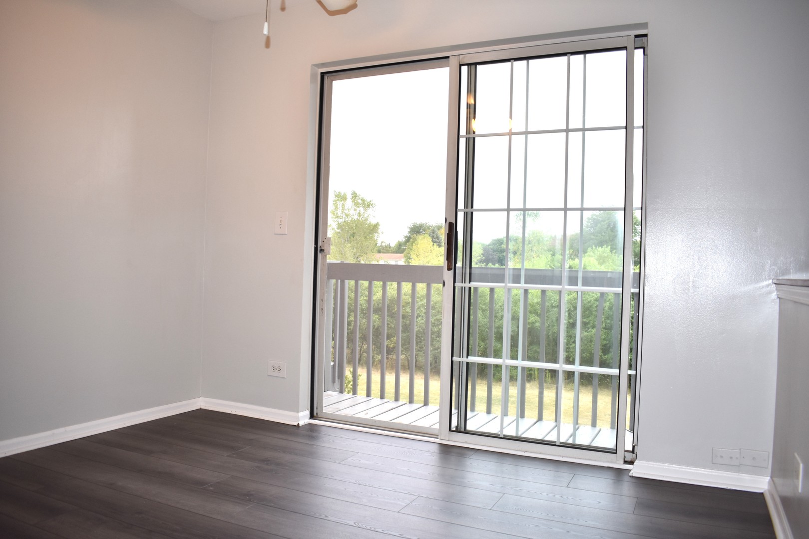 1344 South Lorraine Road, Unit F Wheaton, IL 60189 - Photo 10 of 27 wooden floor in an empty room with a window