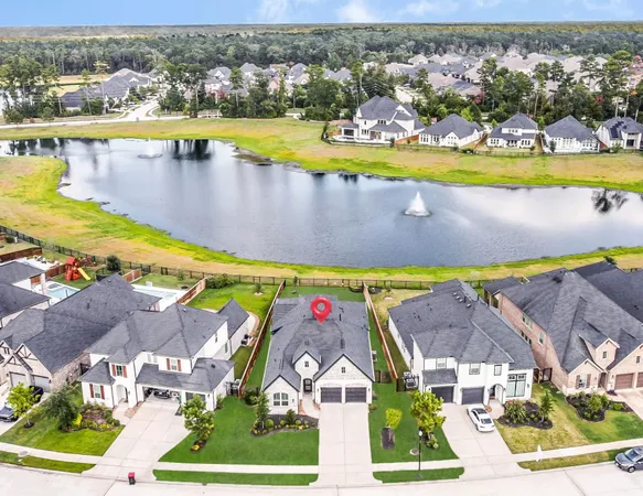 an aerial view of a house with a swimming pool yard and outdoor seating