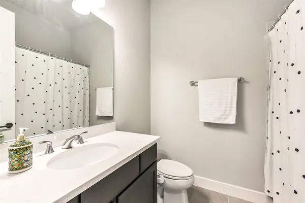 a bathroom with a tub a sink and a mirror
