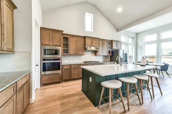 a living room with fireplace furniture and a large window