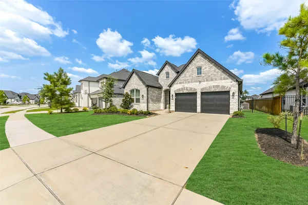 a front view of a house with a garden and plants