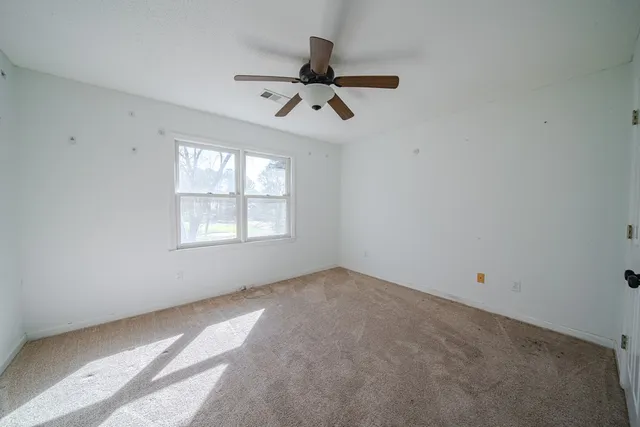 a view of a room with window and hardwood floor