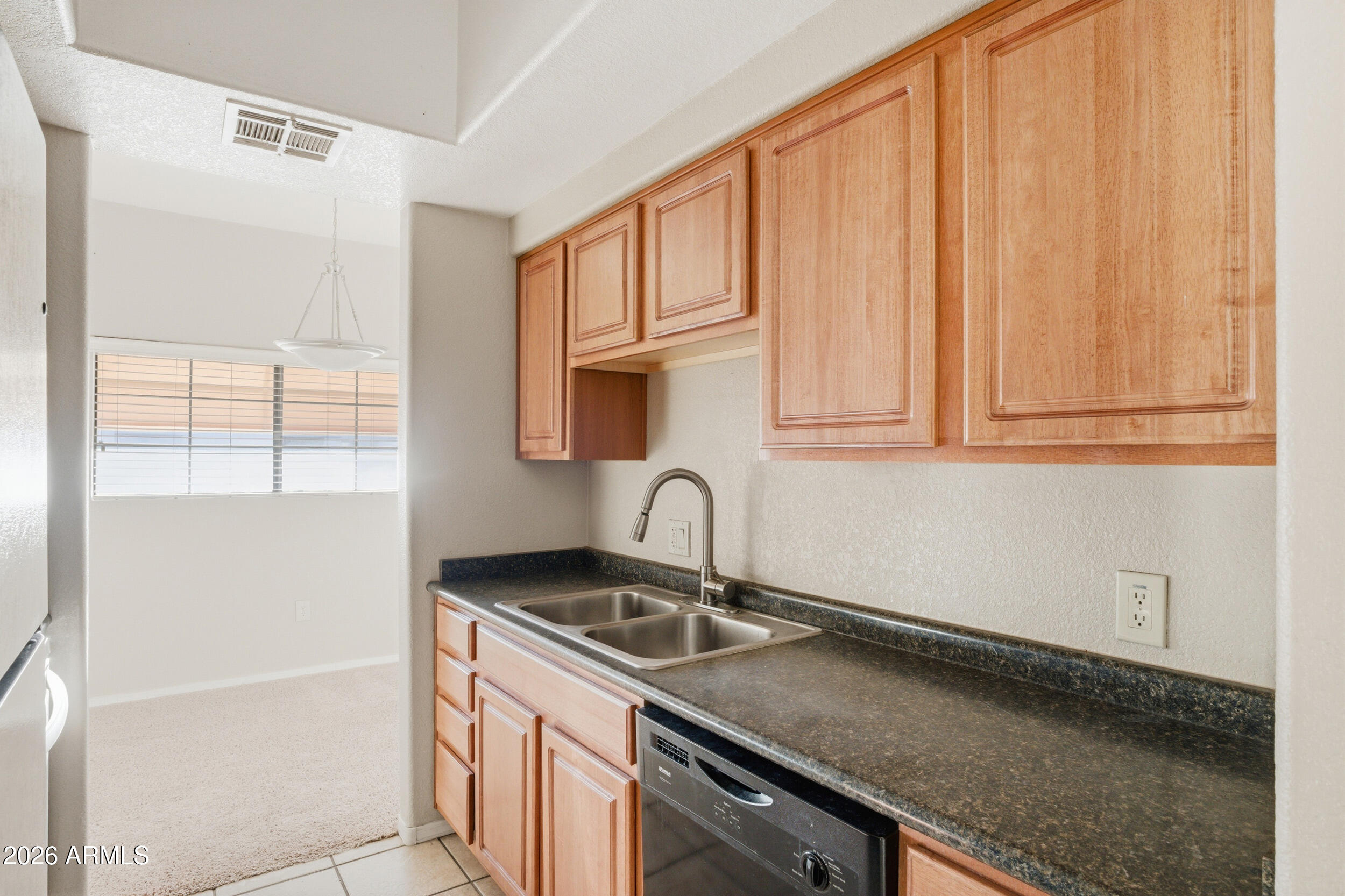 3434 East Baseline Road, Unit 264 Phoenix, AZ 85042 - Photo 7 of 12 a kitchen with granite countertop a sink and a stove top oven