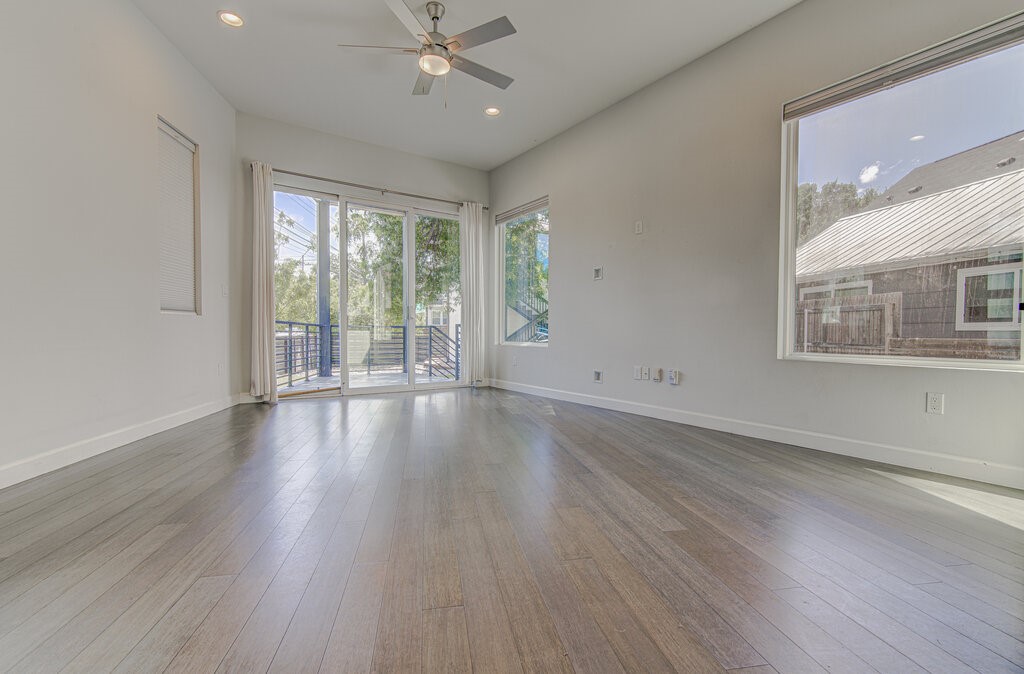 2406 East 16th Street Austin, TX 78702 - Photo 15 of 39 a view of an empty room with wooden floor and a window
