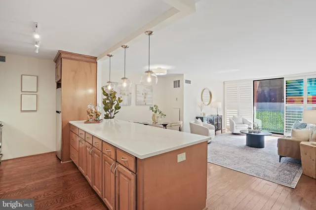 a large white kitchen with a large window