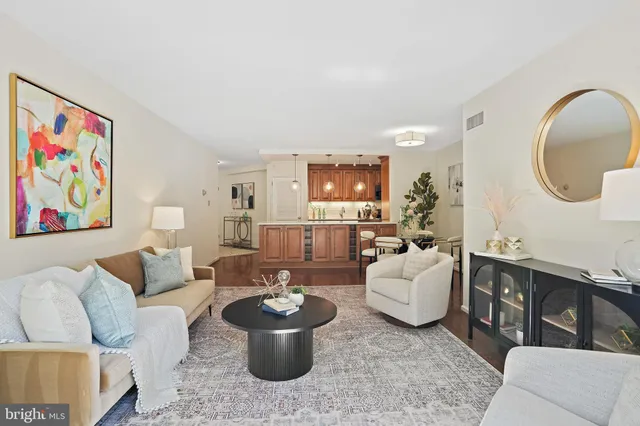 a living room with furniture a rug and a painting