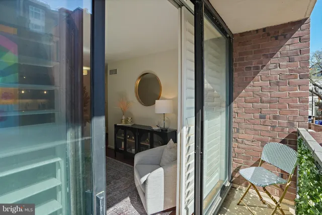 a balcony with table and chairs