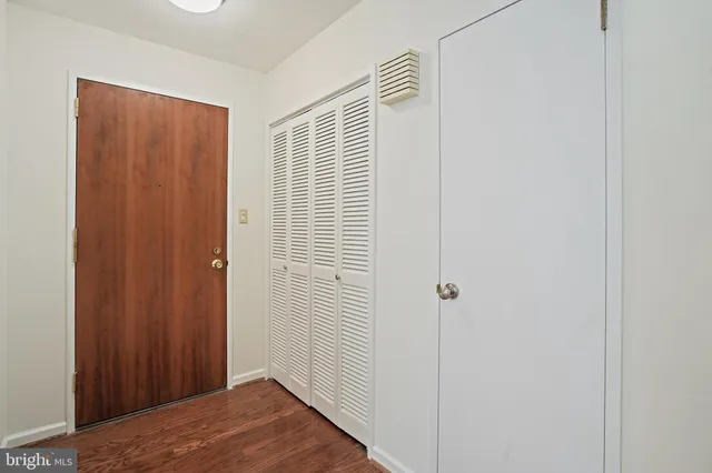 a view of a hallway with wooden floor