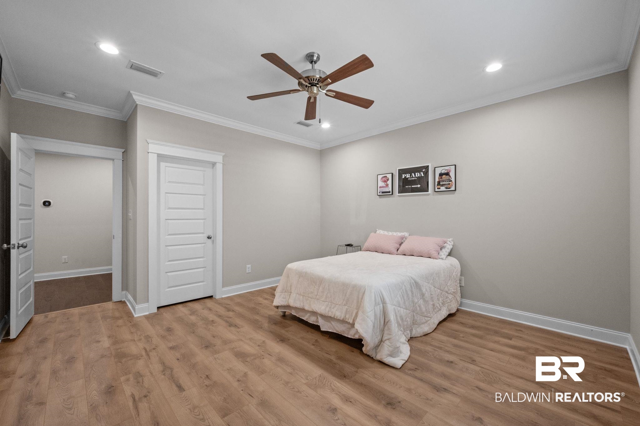 32194 Badger Court Daphne, AL 36527 - Photo 24 of 49 Bedroom with recessed lighting, crown molding, wood finished floors, a ceiling fan, and a closet